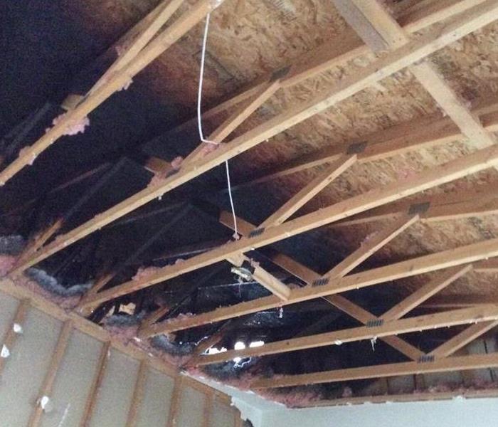 an exposed wood ceiling with black charring