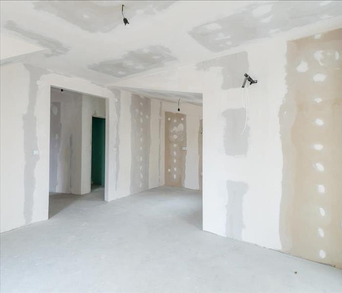 Image of a room with walls resently restored ready to paint. 
